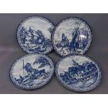 Four blue printed Delfts Blauw Dutch plates with decorative printed scenes, each 12ins diam