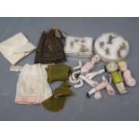 Bag containing mixed miniature bisque dolls and parts together with assorted clothing and two