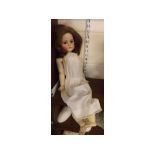 Bisque faced doll with glass eyes, articulated arms and legs in a white gown (a/f), 26ins tall