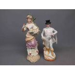 Pair of German lustre and painted figures of a gent wearing a top hat and lady holding a fan (a/