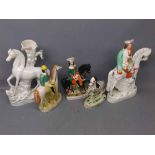 Five assorted Staffordshire type figures to include a zebra, three horse mounted figures and a