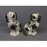 Two 19th century seated Staffordshire dogs, one with a white ground and green lustre ware design and