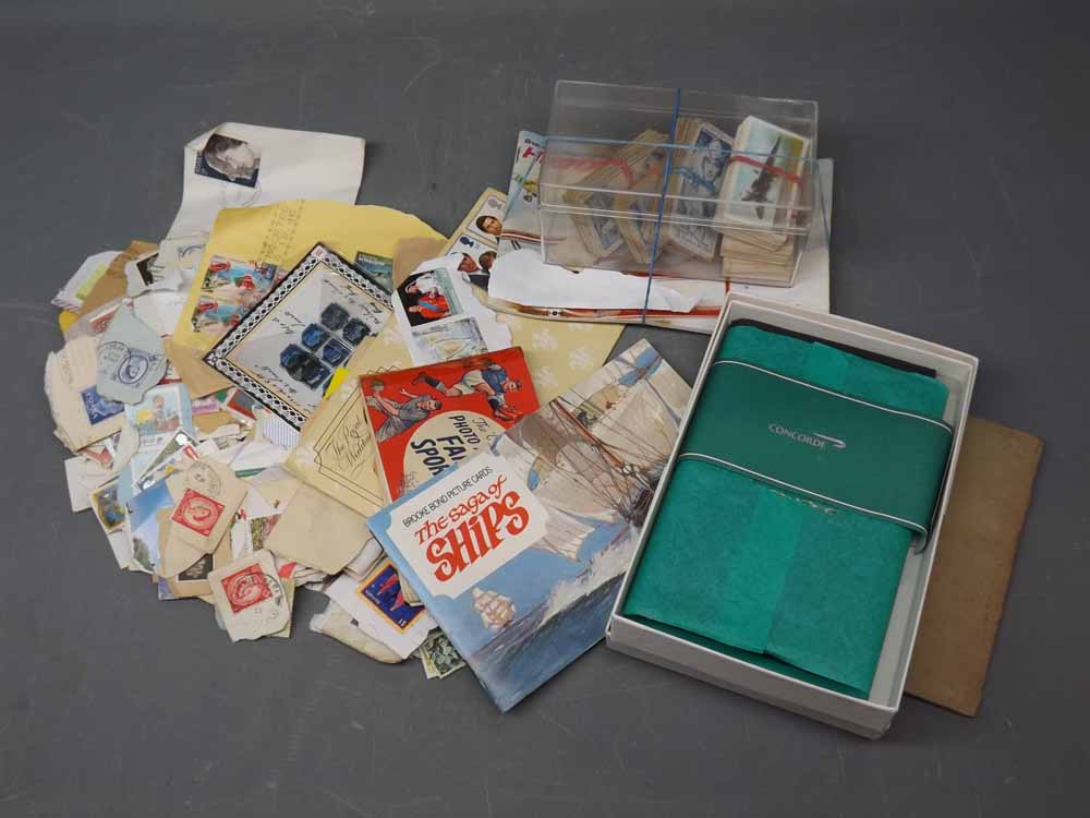 Bag containing a quantity of loose stamps, assorted cigarette cards, boxed Concorde notepad and