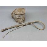 Eastern animal hide covered and stitched flask with a further hide and wooden rustic whip (2)