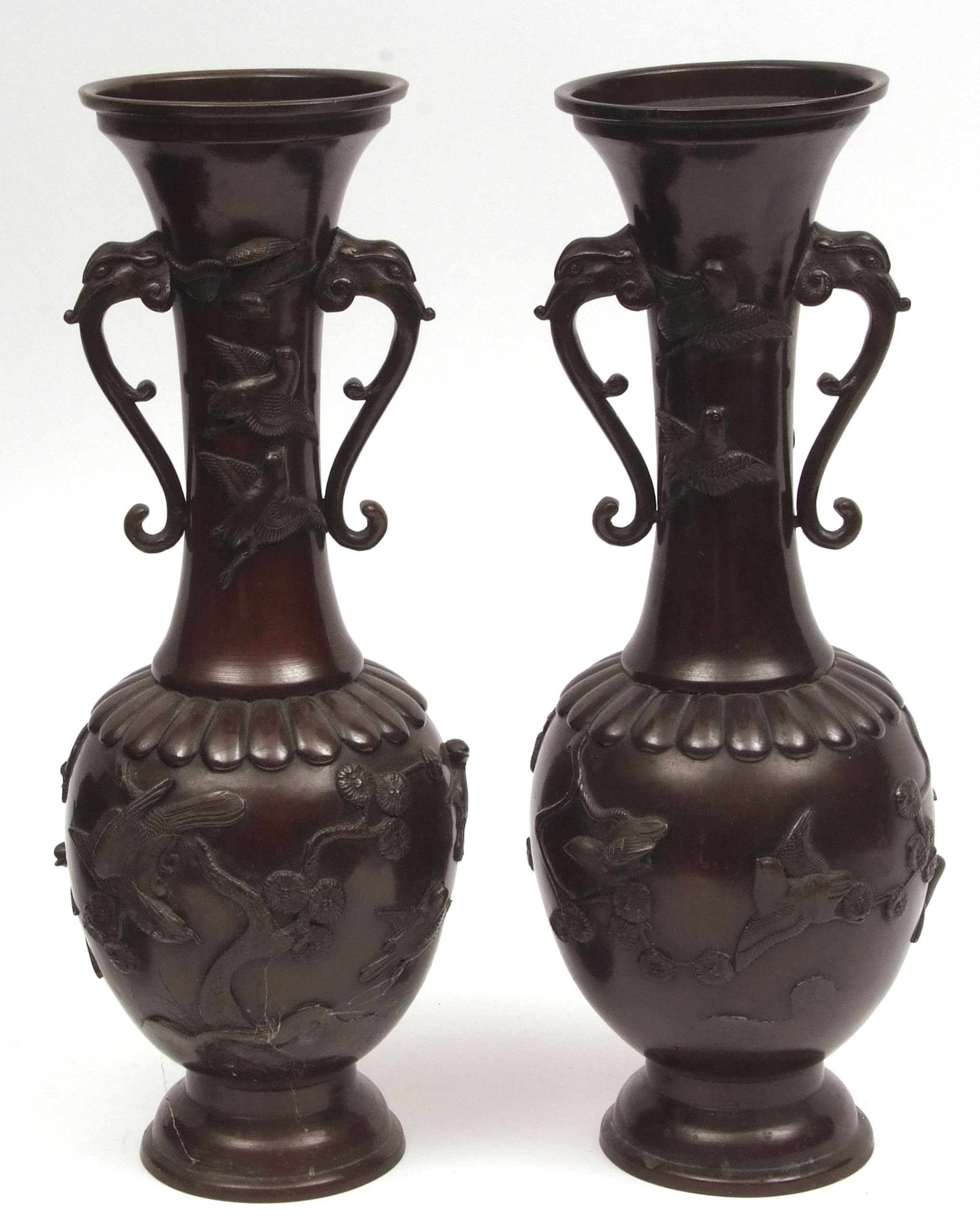 Large pair of Japanese bronze vases with mythical beast handles, heavily cast in high relief with