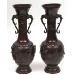 Large pair of Japanese bronze vases with mythical beast handles, heavily cast in high relief with