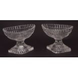 Pair of early 19th century faceted oval pedestal glass salts on diamond shaped bases, 3ins high