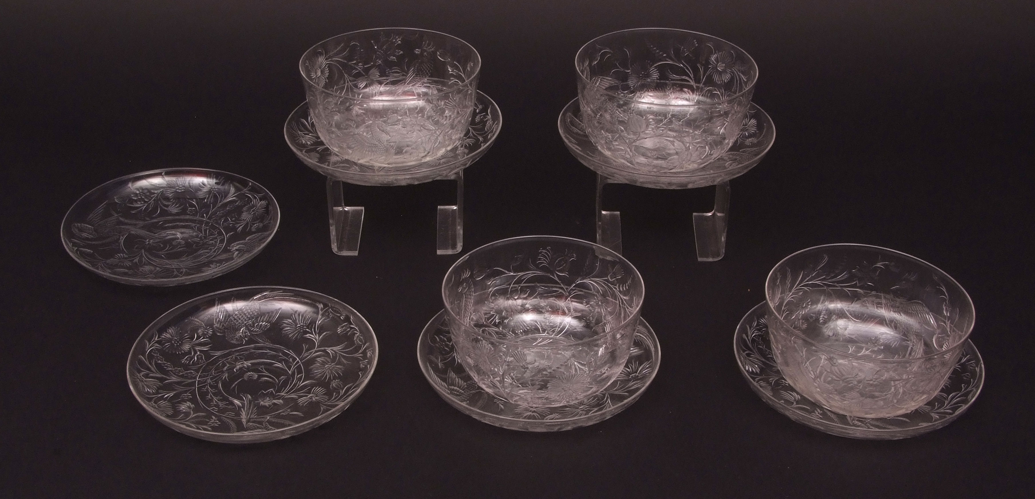 Set of four decorative finely engraved glass finger bowls and six saucers, engraved with game