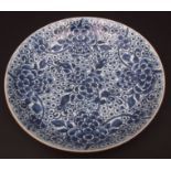Large provincial Chinese blue and white porcelain dish decorated with scrolling flowers and foliage,