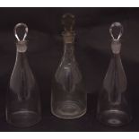 Three various small bottle-shaped decanters with pear stoppers, 10ins high