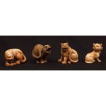 Four Japanese ivory netsuke, all early 20th century, three tigers and a seated cat
