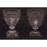 Two Regency wine glasses, with faceted bodies, stepped spreading square bases, 6ins high