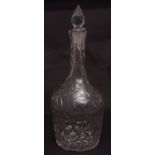 Decorative heavily faceted bottle-shaped decanter with conical stopper and star cut foot, 12 1/2 ins