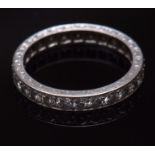 Precious metal diamond full eternity ring, having twenty six small single cut diamonds, claw set