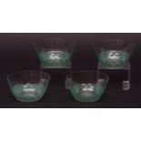 Set of four Lalique bowls, each decorated with a frieze of leaping fish in green enamel, circa