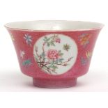 Fine Chinese coral ground medallion bowl with everted rim, the ground with scattered floral sprays