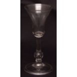 Late 18th century balustroid wine glass with funnel bowl and air drop stem, spreading circular