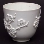 Bow white coffee cup, circa 1760, moulded or applied with prunus sprays and scroll handle, 2 1/2 ins