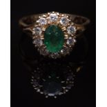 Mid-20th century 18ct gold emerald and diamond cluster ring, the oval cut emerald (8mm x 5mm approx)