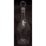 Decorative faceted bottle shaped decanter with pear stopper, on a star cut base, 12ins high
