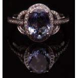 Modern precious metal tanzanite and diamond ring, the oval cut tanzanite approx 1.87ct, raised