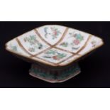 Small Chinese porcelain footed dish of square form decorated in famille rose enamels, with panels of