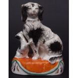 Late 19th century Staffordshire group of a spaniel and pup with black sponged decoration on oval