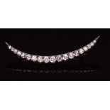 Victorian precious metal and diamond crescent brooch, set with nineteen graduated old cut