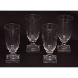 Set of four half fluted wine glasses with square bases, circa early 19th century, 5 1/2 ins high