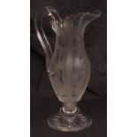 Glass wine jug of oval baluster form, engraved with panels of fruiting vines, interspersed with