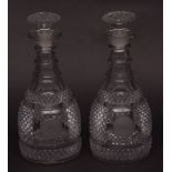 Pair of 19th century bottle-shaped decanters, each with triple knopped necks, heavily hobnail cut