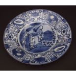 Japanese Kraak type small charger, decorated in underglaze blue with typical reserved panels of