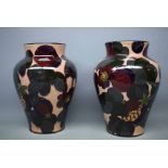 Pair of Tuscan faience pottery vases in a plant pattern, 8ins tall