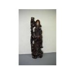 Large Chinese root carved figure of an old sage with a staff in his hand and a crane at his feet,