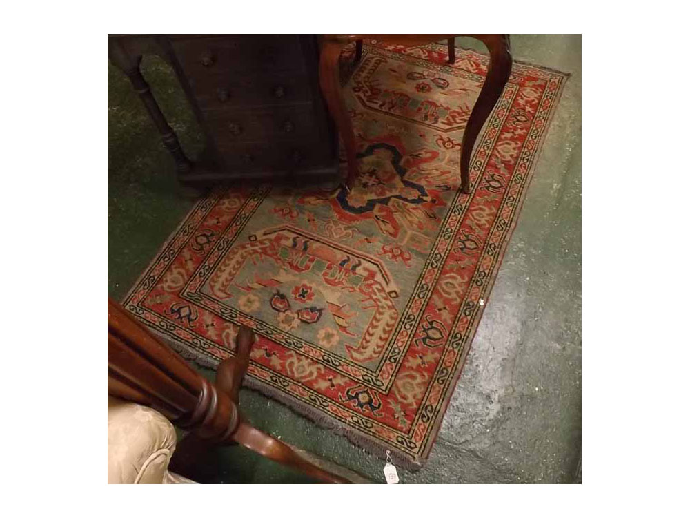 Caucasian small rug with central panel of three geometric lozenges, mainly faded pale blue and red