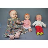 Collection of three various plastic or composition dolls