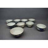 Nine Chinese blue and white printed tea bowls with silver plated rims, varying scenes, largest