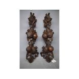 Pair of carved wooden furniture mounts, 18ins long