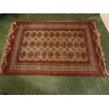 Caucasian rug, multi-gulled border, central panel of lozenges, beige and red field, 74 x 55ins