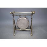 Small silver plated gong with striker, 6 + ins wide