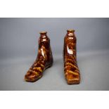 Two treacle glazed decanters modelled as boots, 6ins tall