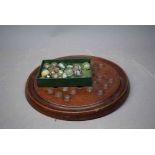 Mahogany solitaire board and small collection of marbles