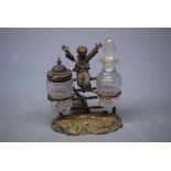 Unusual silver plated two-bottle cruet, the stand in the form of a boy leaping a fence, 5ins high