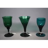 Three 19th century Bristol green wine glasses of varying sizes, largest 5ins tall