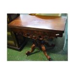 Victorian mahogany fold-over tea table with scrolling carved fretwork on a bulbous column and a