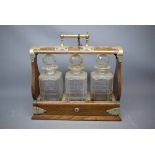 Late 19th/early 20th century three-bottle Tantalus, 12ins wide