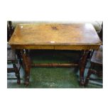 Victorian walnut two-drawer side table on four reeded columns terminating on scrolling legs and