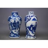 Two 19th century blue and white vases with lozenge showing a vase of flowers, the other showing