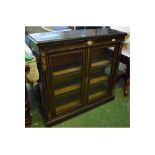 19th century ebonised display cabinet with two glazed doors and gilt mounts, central oval