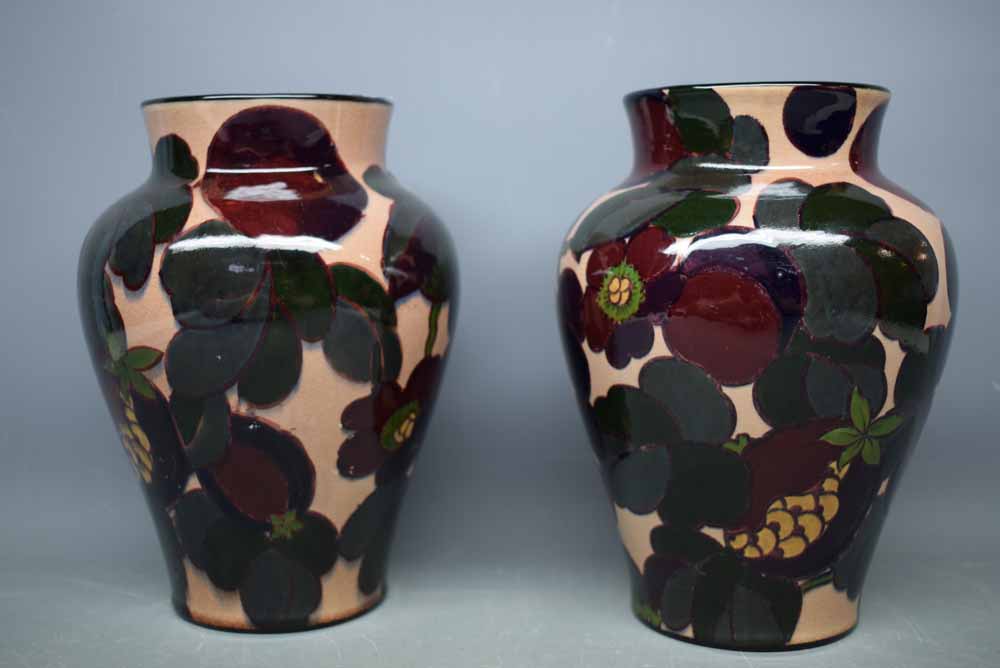 Pair of Tuscan faience pottery vases in a plant pattern, 8ins tall
